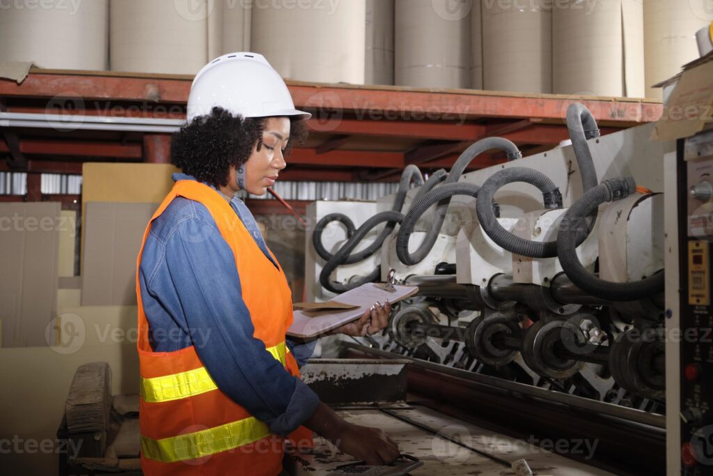 a lady who is maintaining industrial equipment 